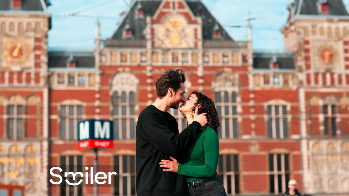 Traveller photographed in front of the 1889 Centraal Station facade during an Amsterdam photoshoot, Amsterdam